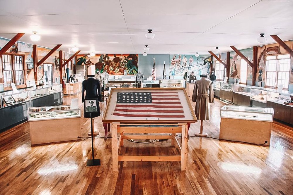 Interior of museum with a display of the United States Flag.