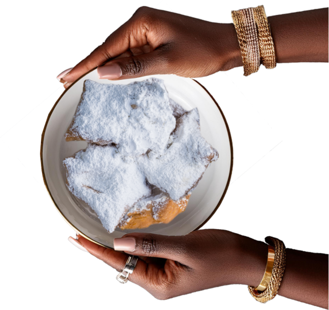 Hands Holding a Dish of Louisiana Beignets