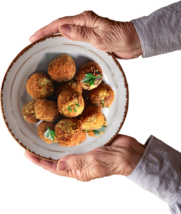 Hands Holding a Dish of Louisiana Boudin Balls